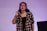 A woman standing in front of a projection screen