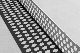 A black and white photo of a metal grate