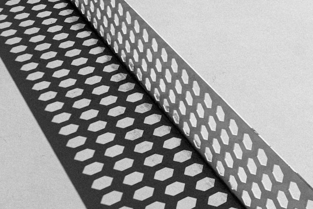 A black and white photo of a metal grate