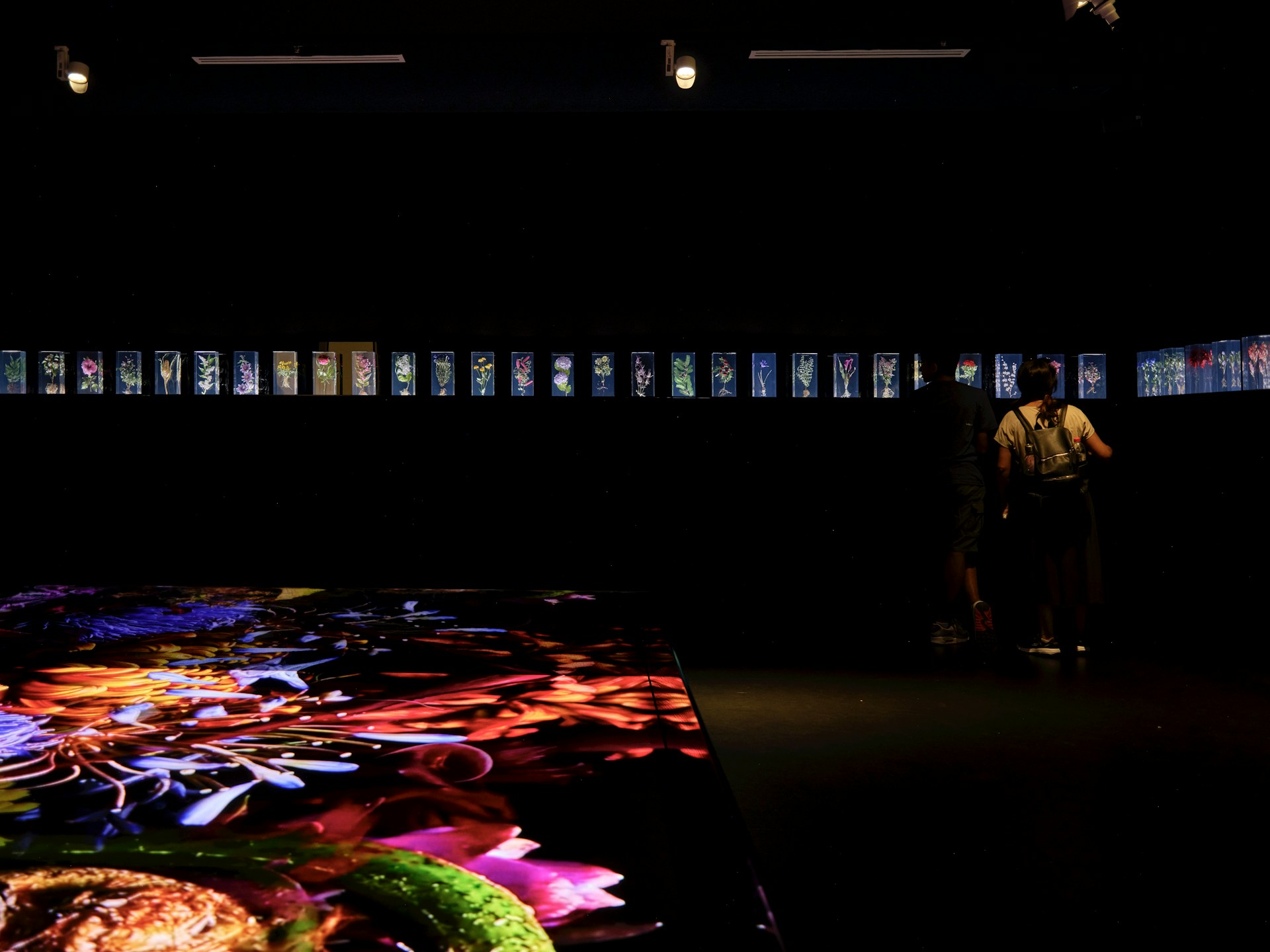 A man standing in front of a large display of food