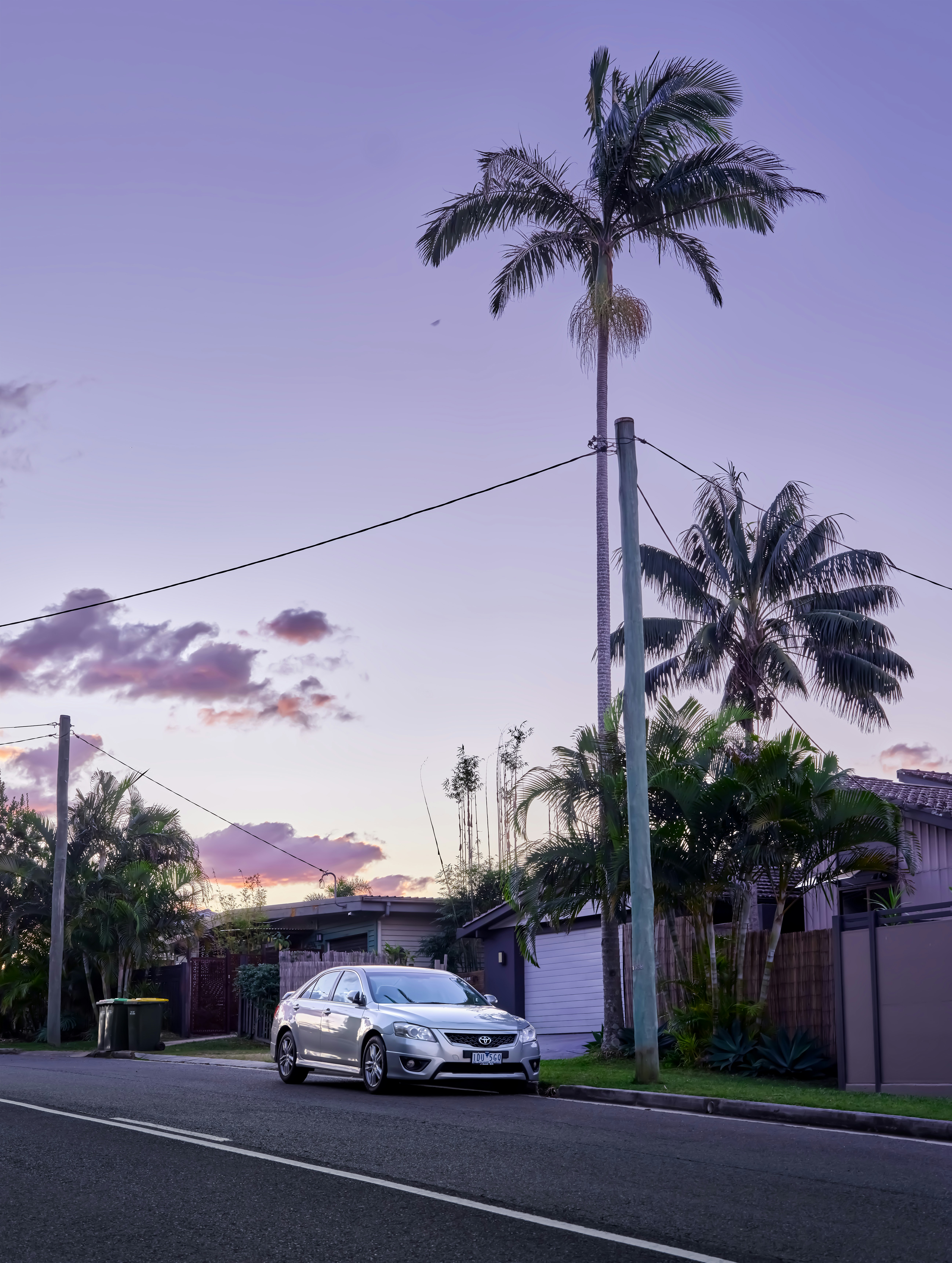 A white car parked on the side of a road