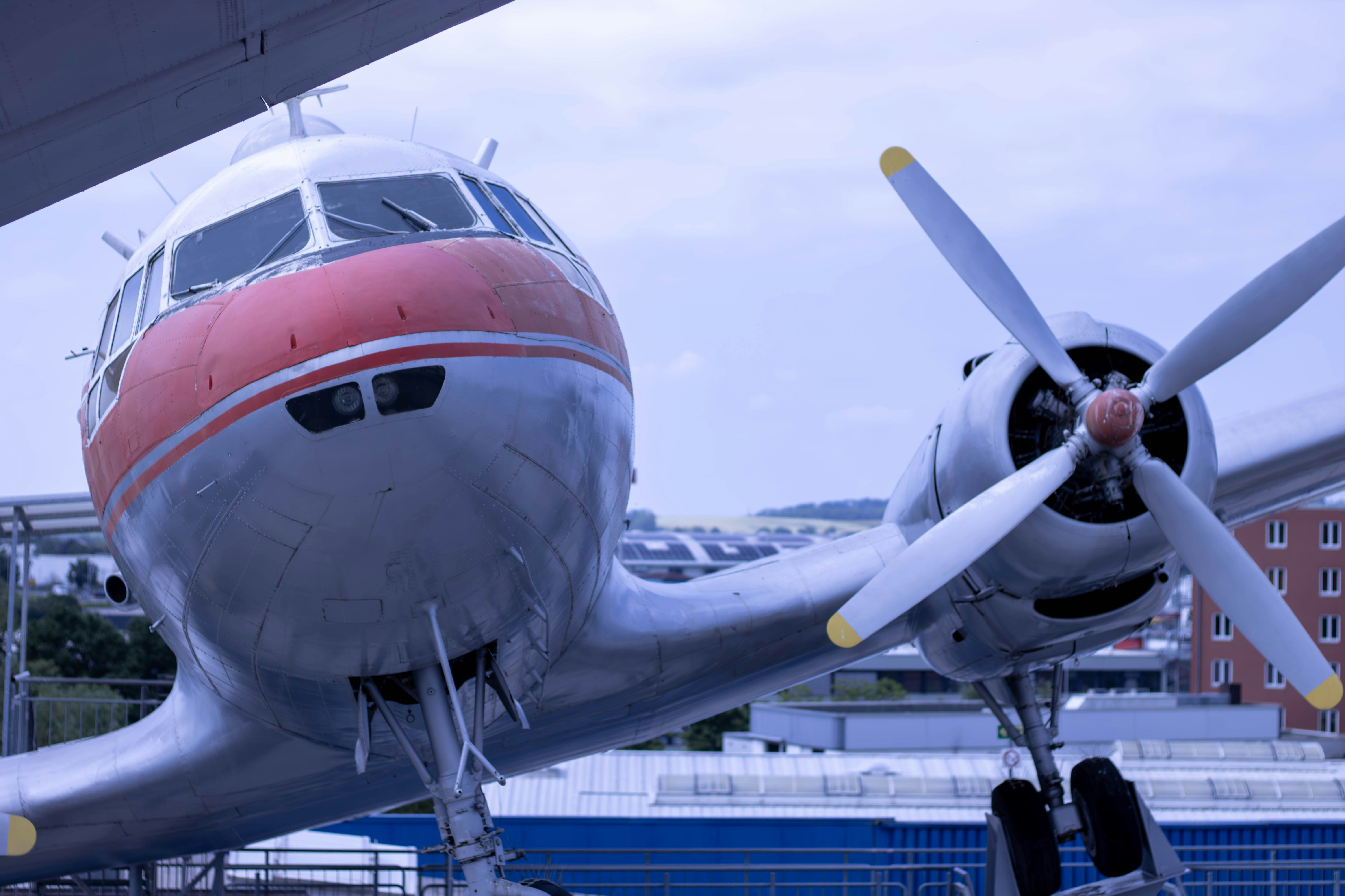 A propeller plane sitting on top of a tarmac, 