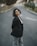 A woman standing in the middle of a street