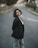 A woman standing in the middle of a street