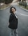 A woman standing in the middle of a street