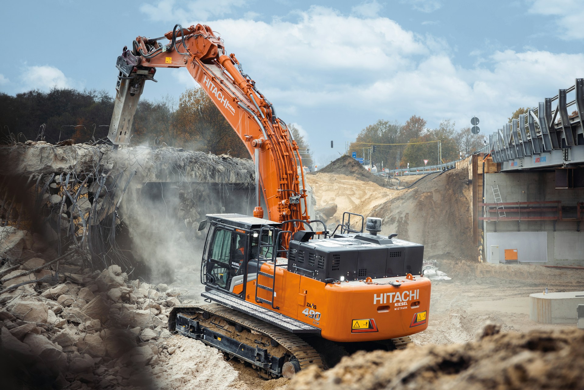 An orange excavator digging dirt in a construction site