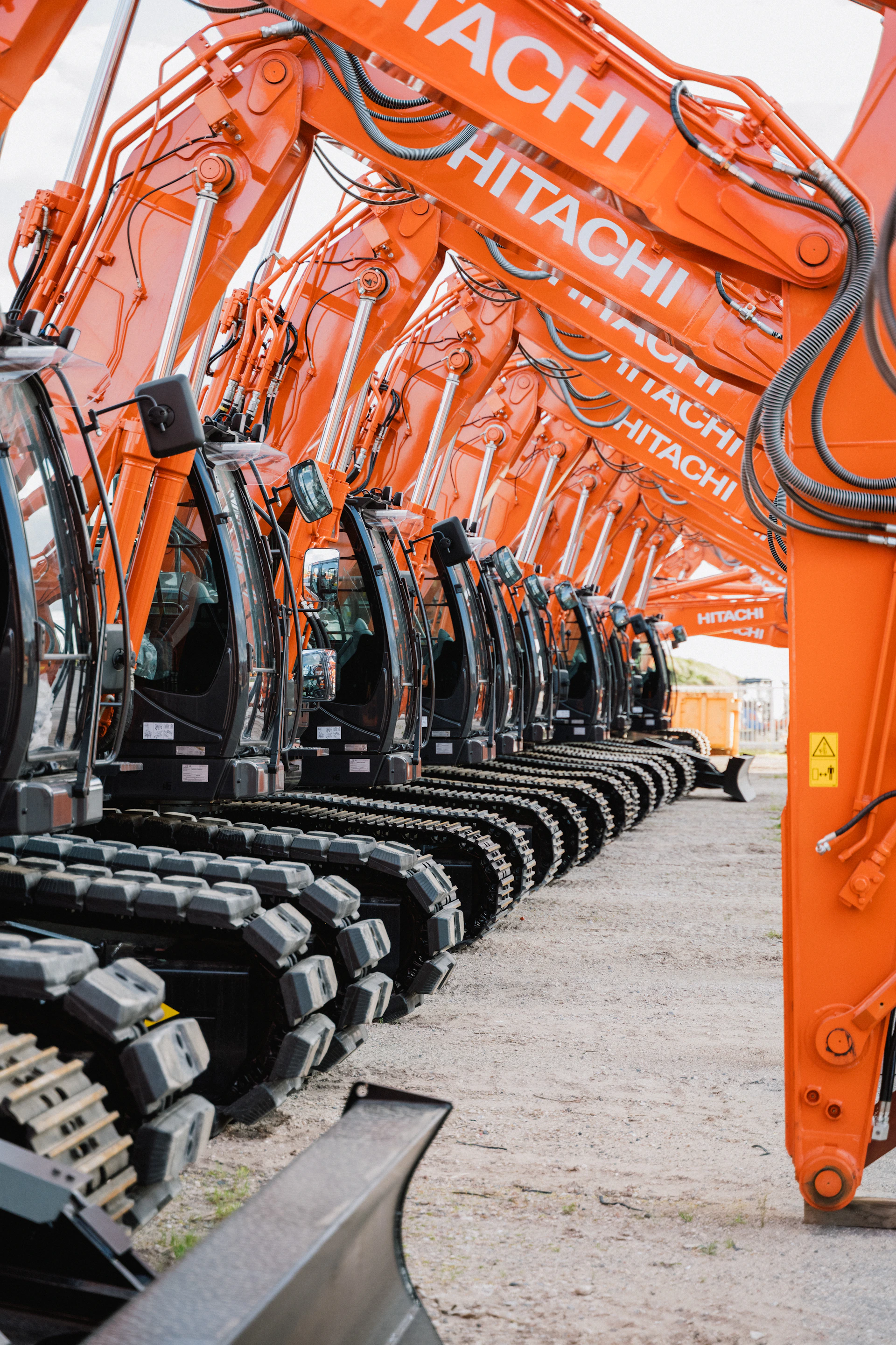 A row of orange machines sitting next to each other