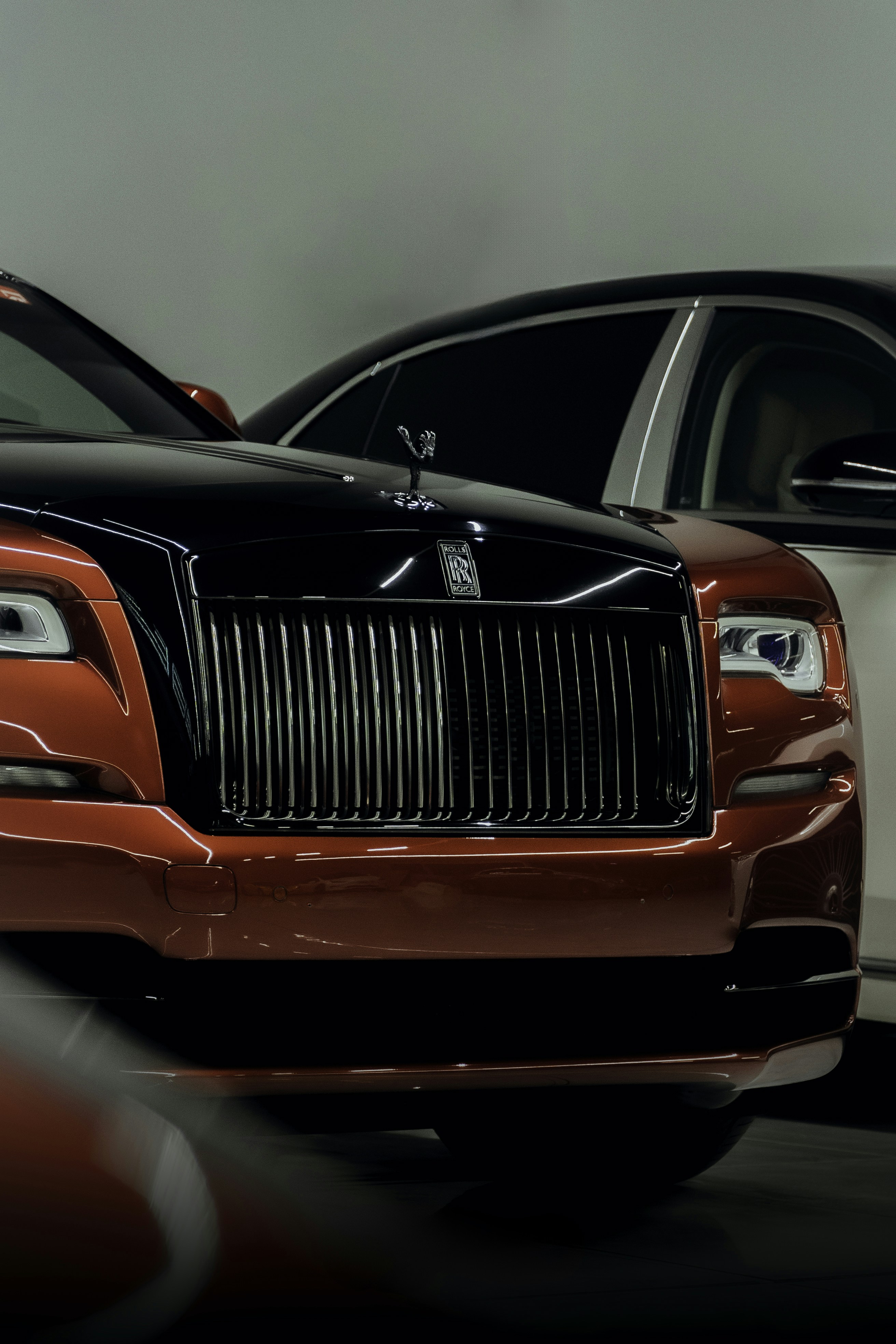 Two rolls royces parked next to each other