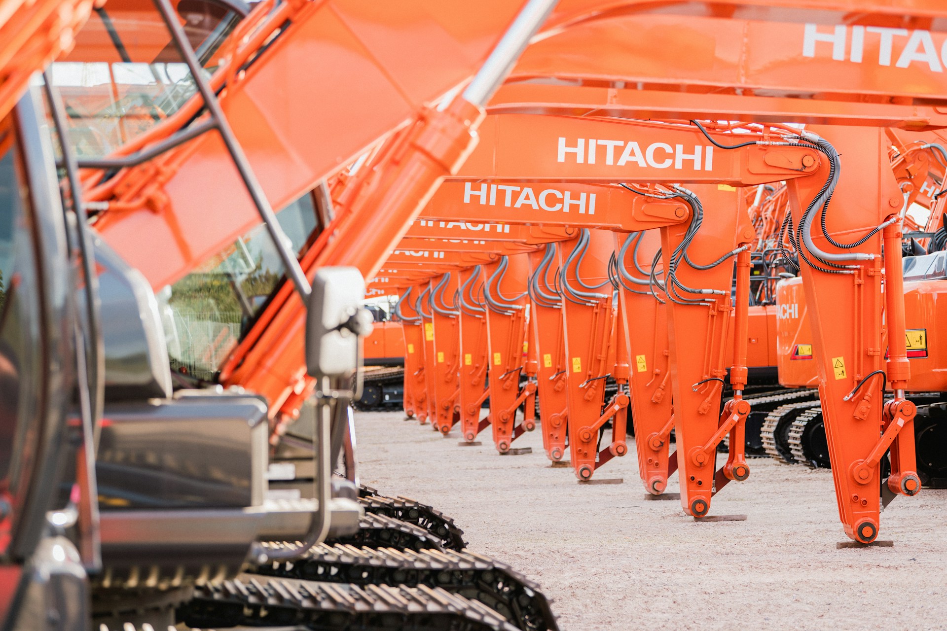 A group of orange trucks parked next to each other