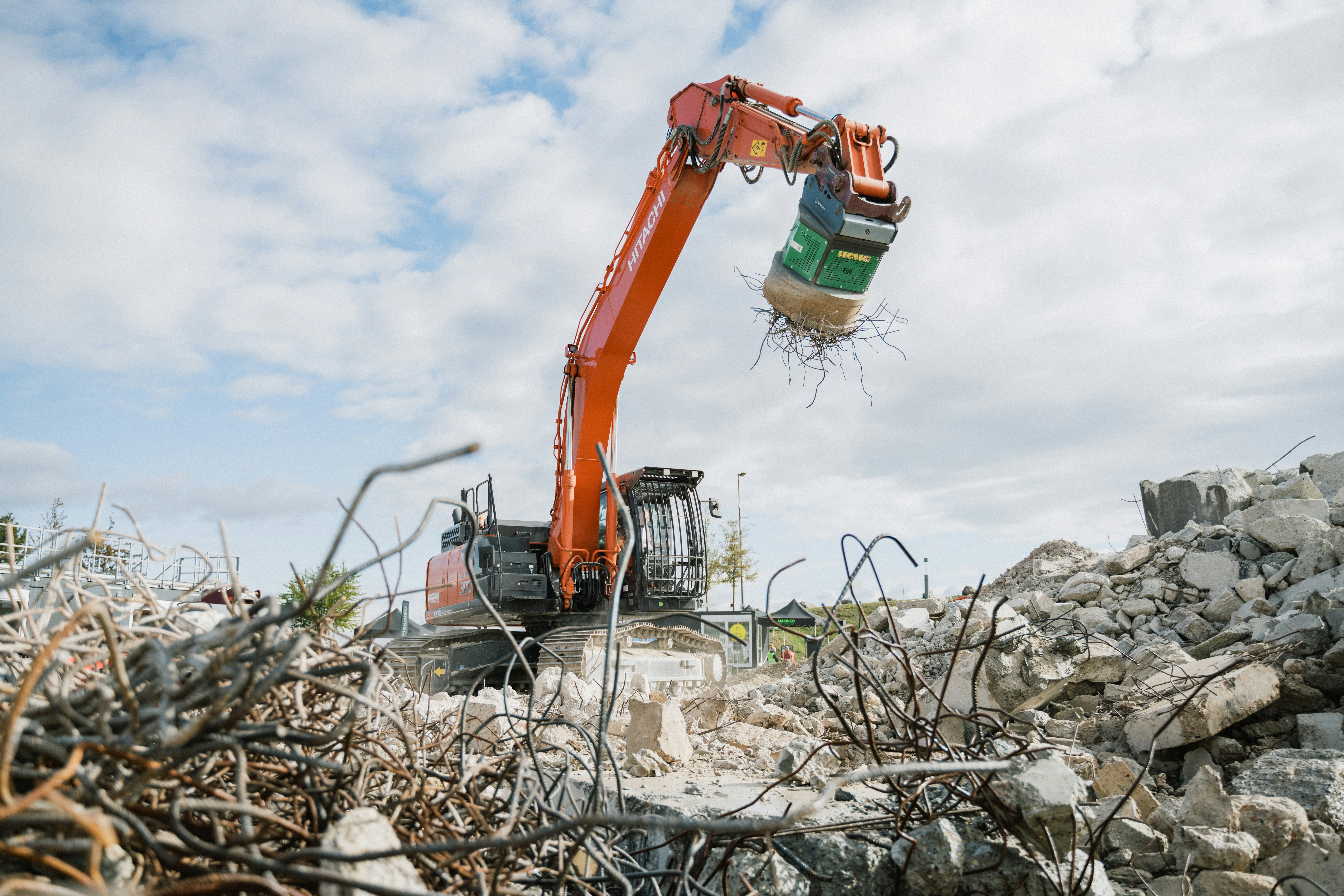 A crane is lifting a pile of rubble