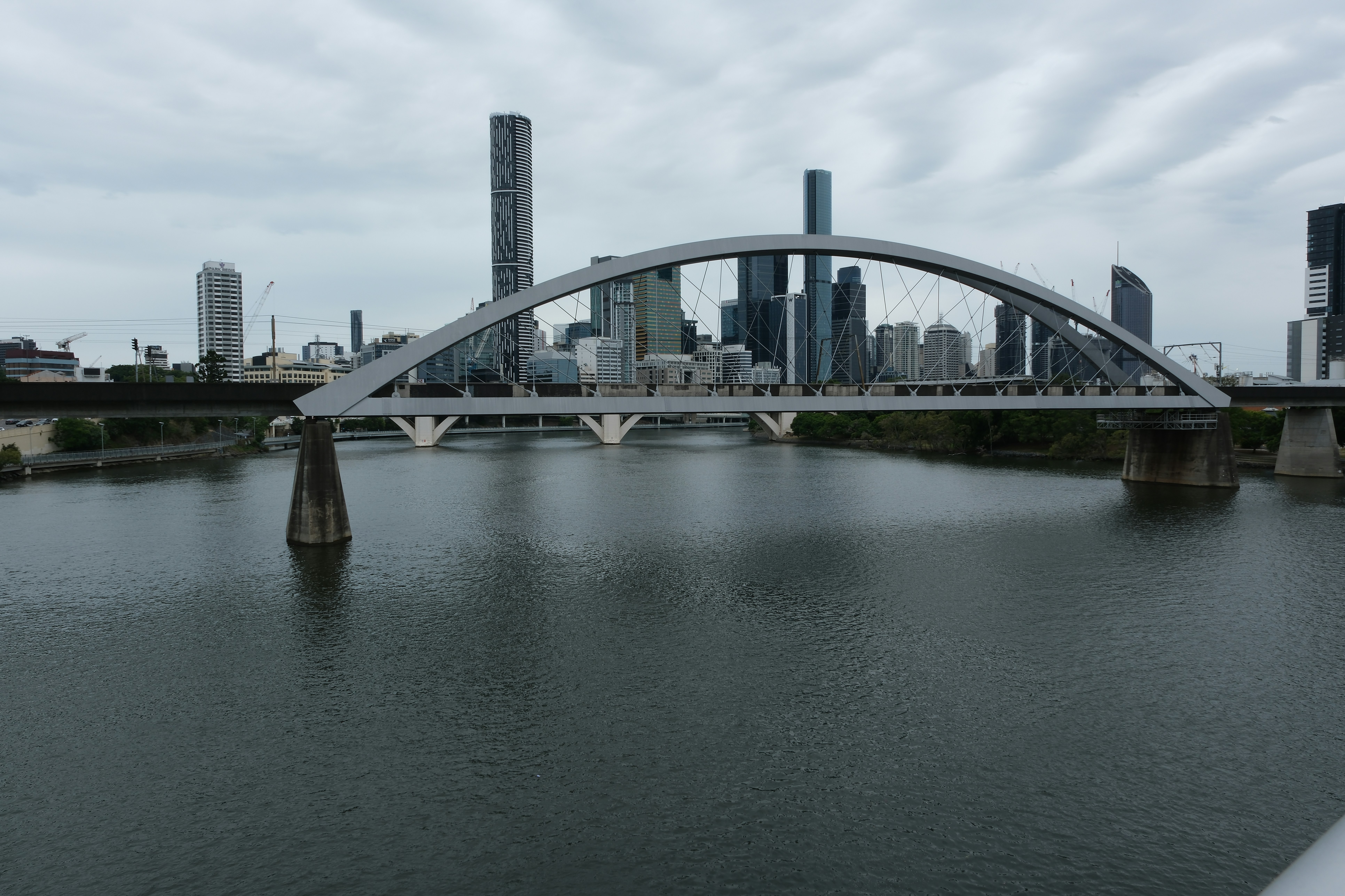 A bridge over a river with a city in the background