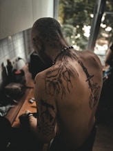 A man with a tree tattoo on his back