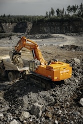 A construction vehicle is parked on a pile of rocks