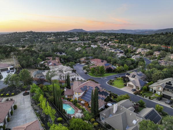 Aerial view of a Southern Nevada style suburban neighborhood at sunset with rows of single family homes