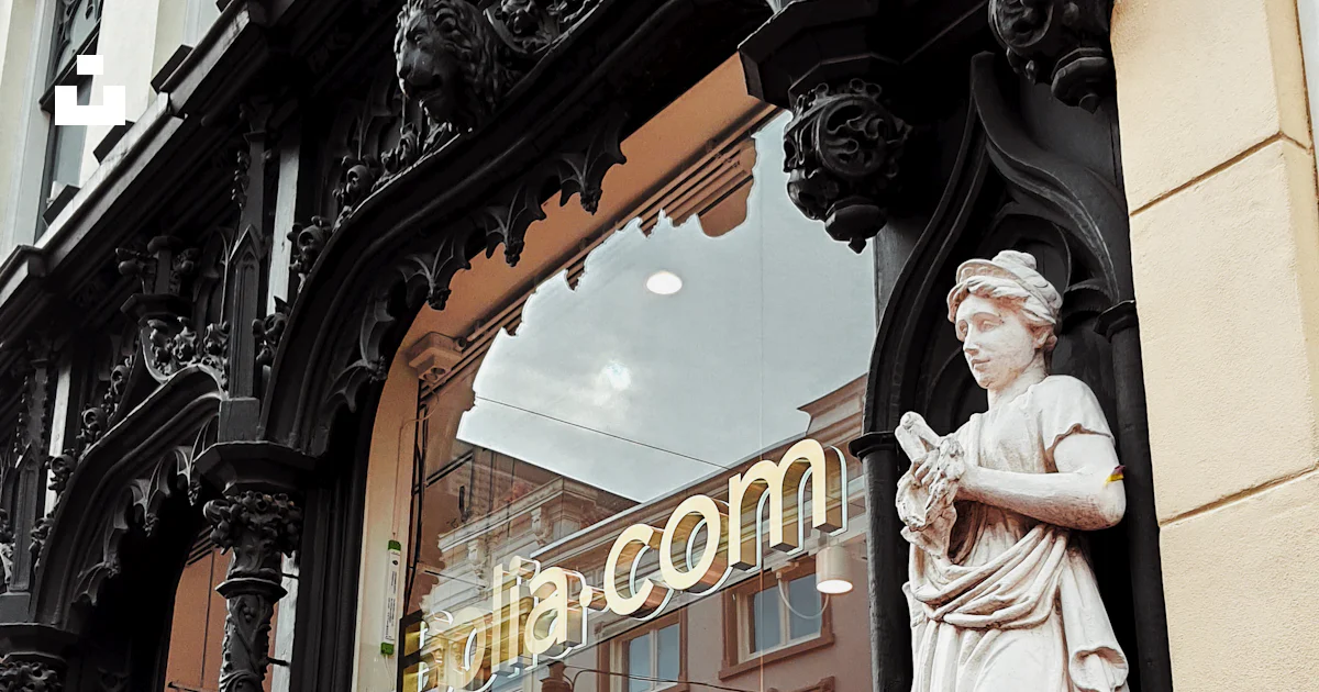 A storefront with a statue of a woman in front of it photo – Free ...
