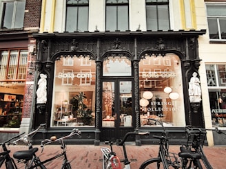 A couple of bikes parked in front of a store