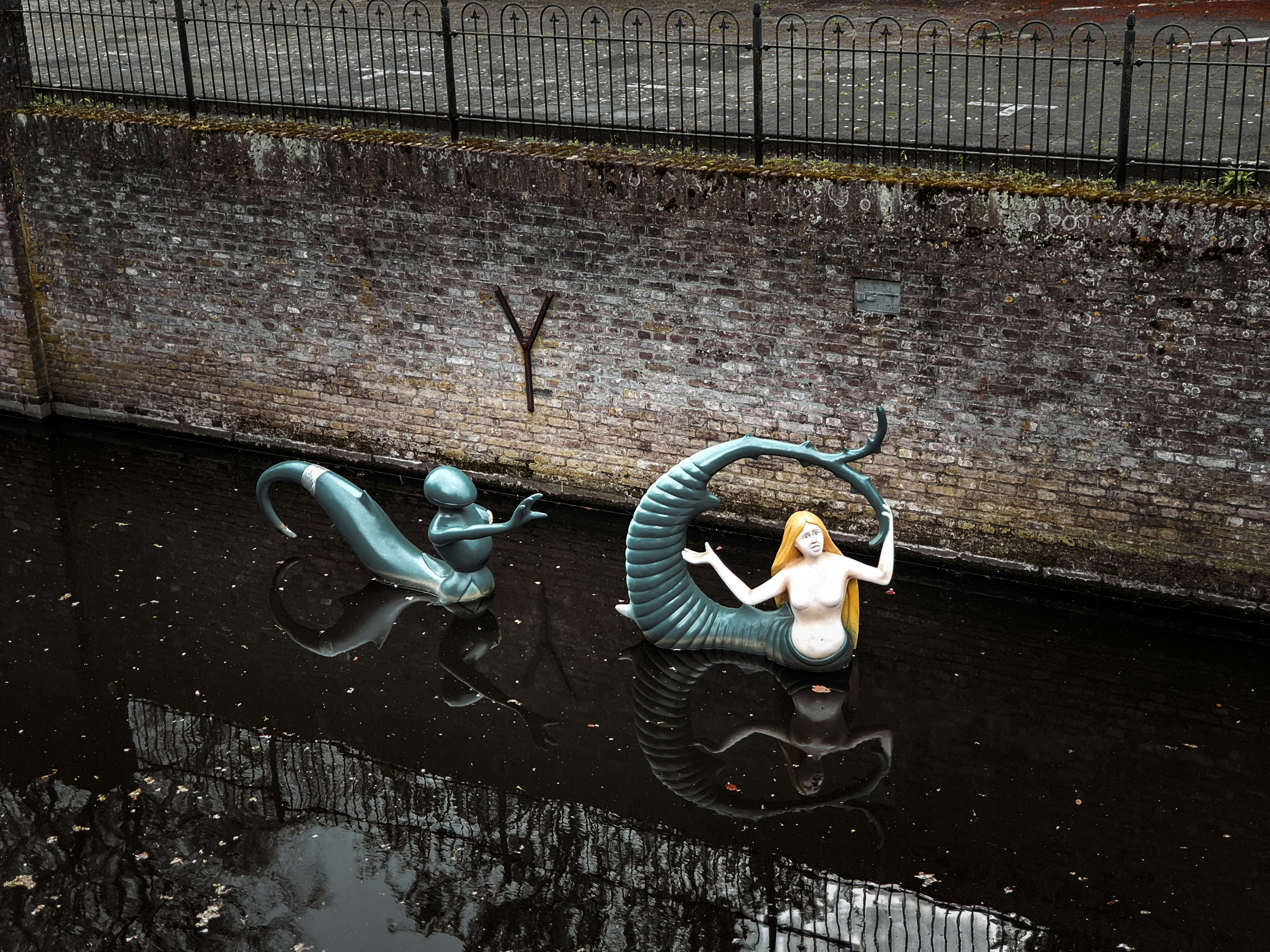A statue of a woman sitting in a pool of water