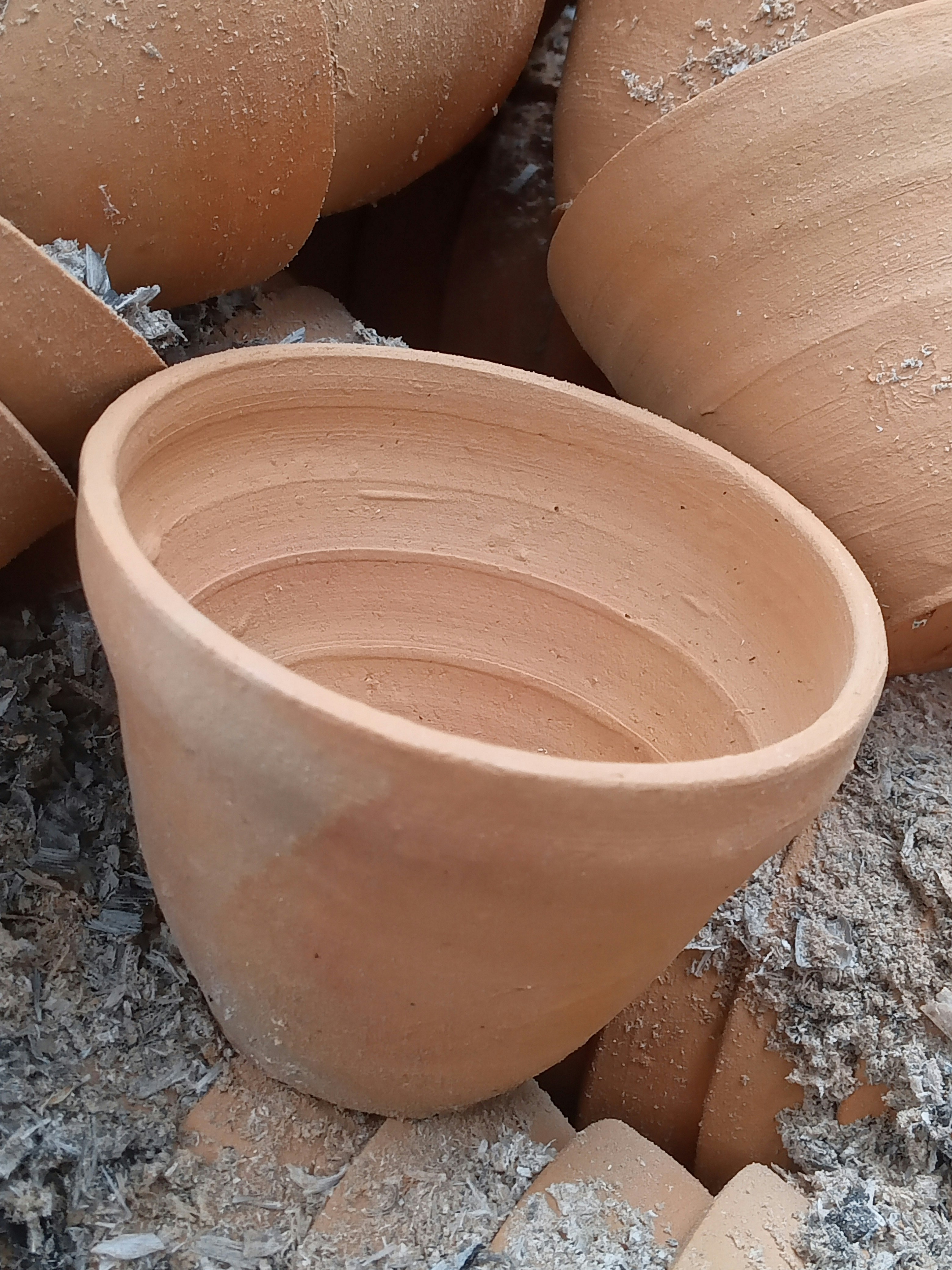 Close-up of terracotta bowl rim showing natural glaze texture and earthy tones