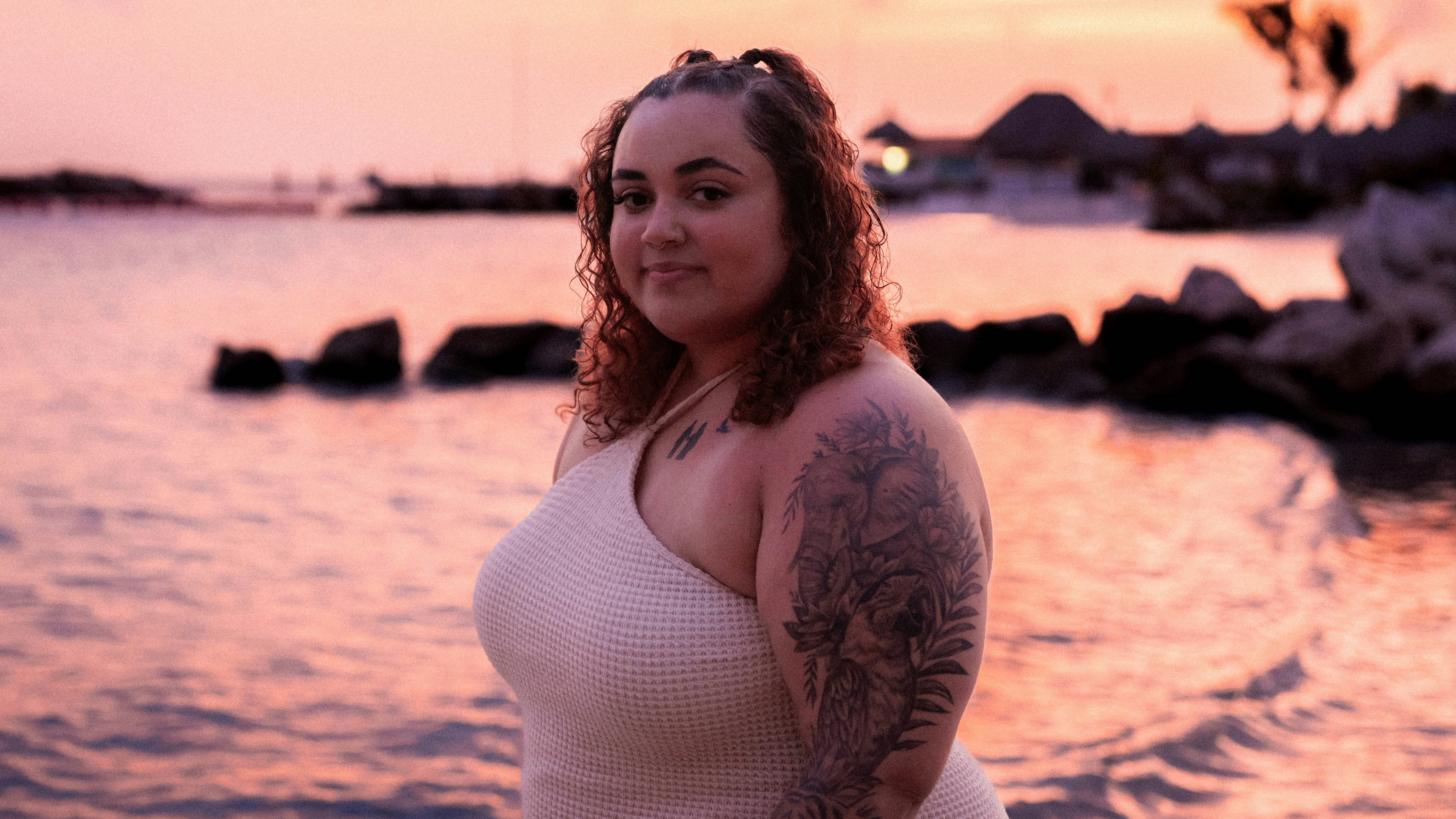 A woman standing in front of a body of water