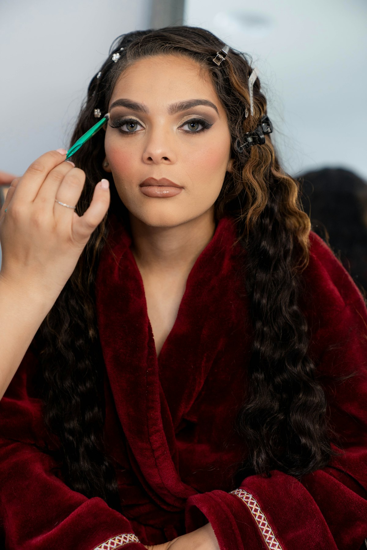Snair applying makeup to a client