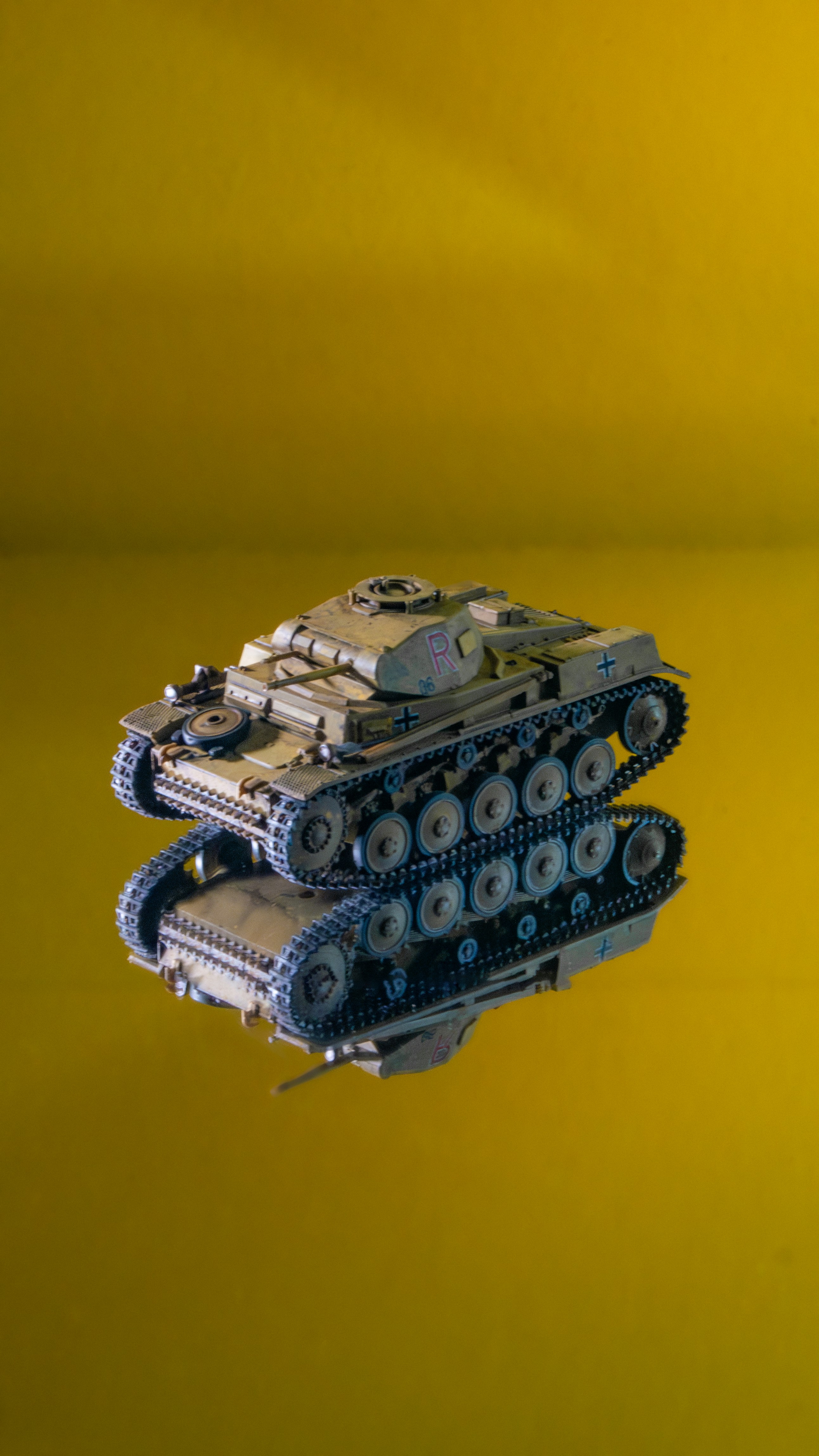 My miniature model of the Panzer II in front of a monochrome photo background on a mirror