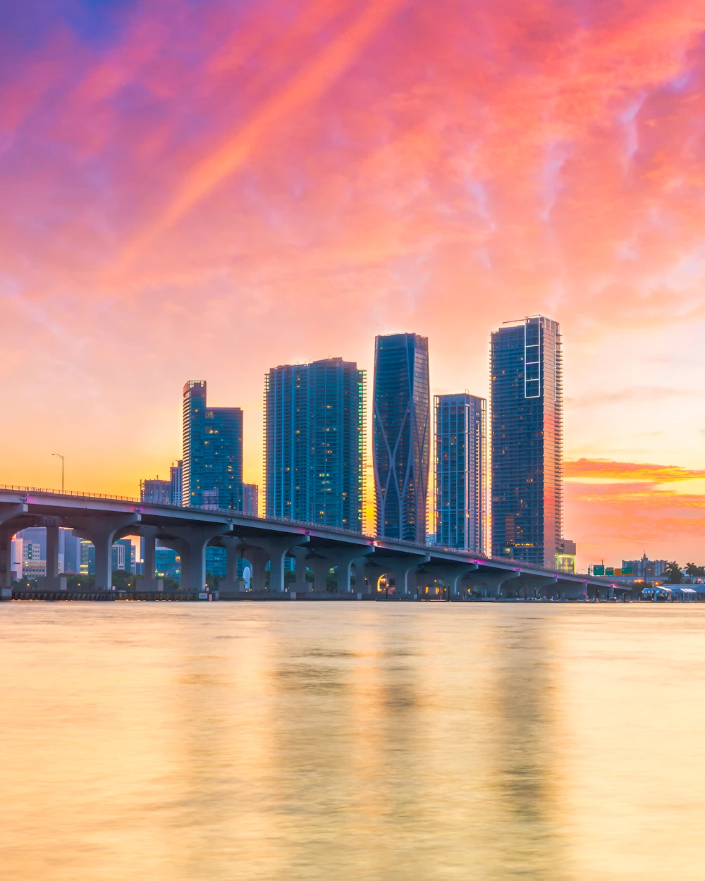 Miami skyline and causeway reflected in Biscayne Bay at sunset