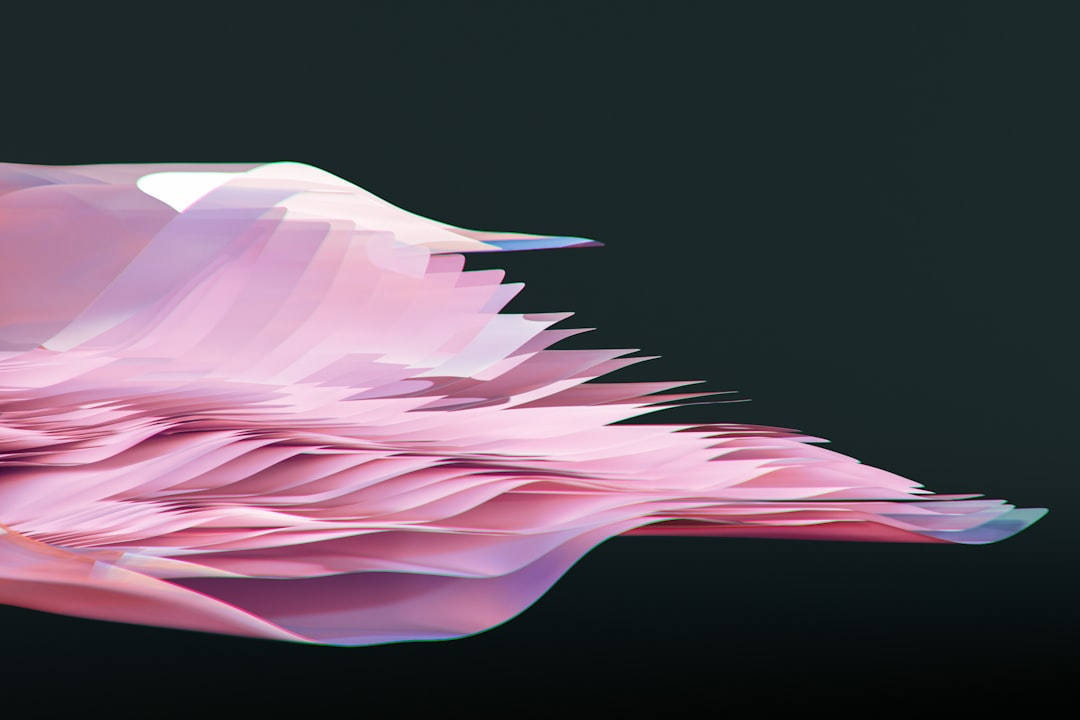 A pink flower floating on top of a body of water,