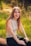 A woman sitting on a bench in a park