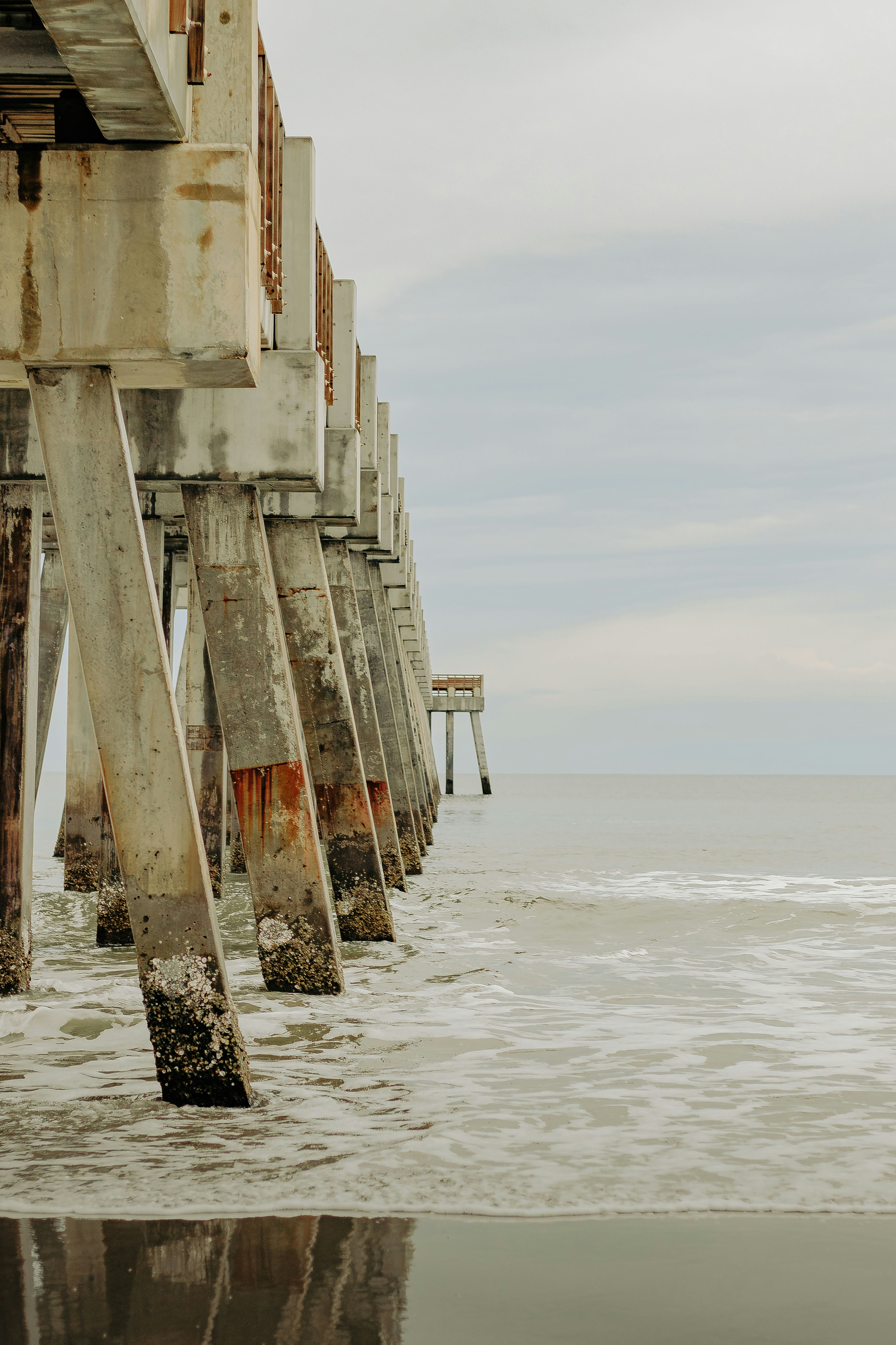 A long pier stretches out into the ocean