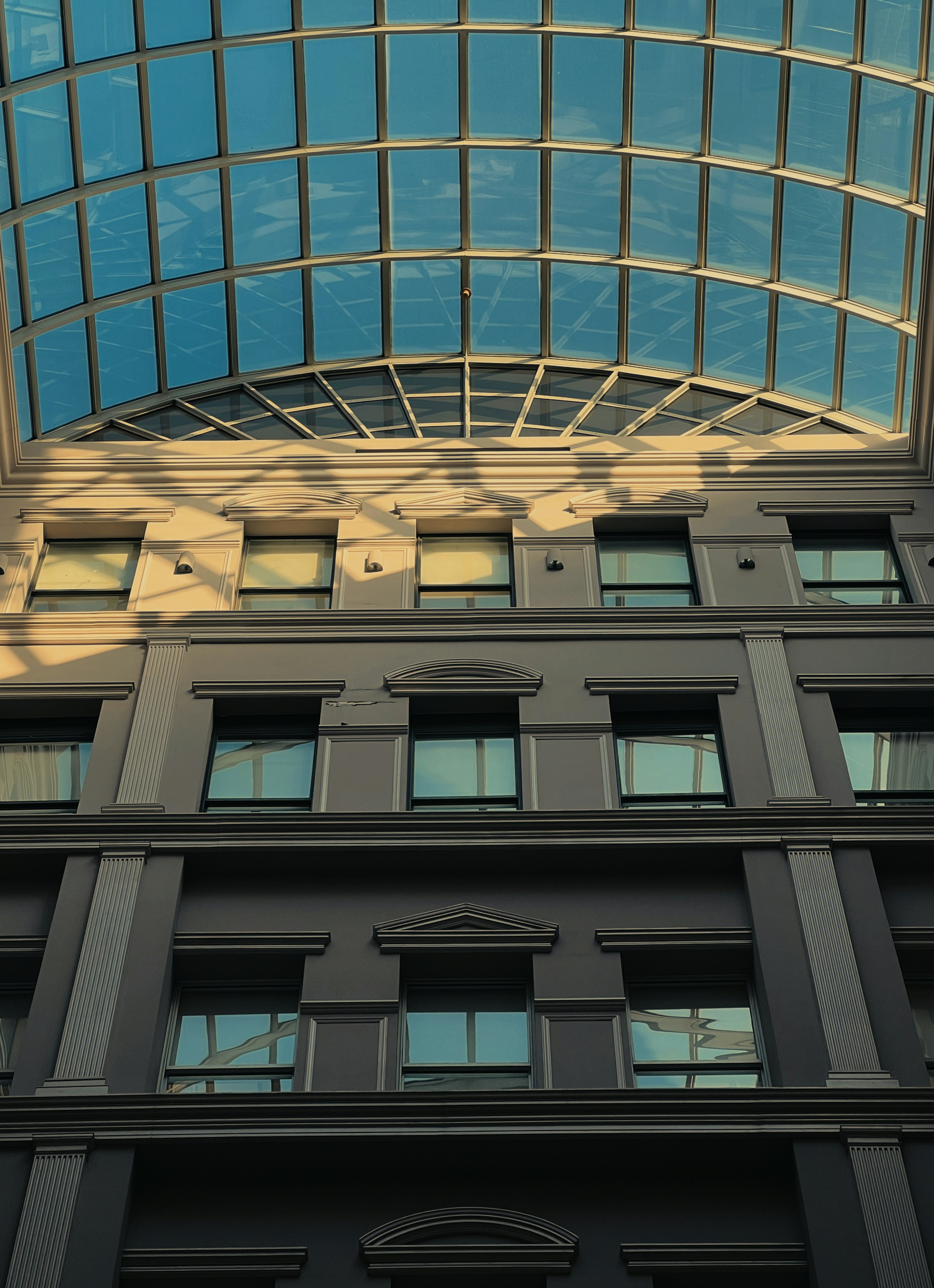 A tall building with lots of windows and a skylight