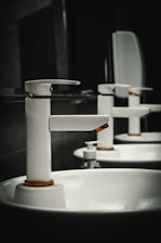 A row of white sinks in a bathroom