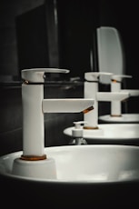 A row of white sinks in a bathroom