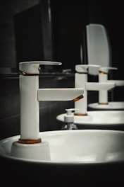 A row of white sinks in a bathroom