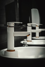 A row of white sinks in a bathroom