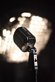 A microphone with lights in the background