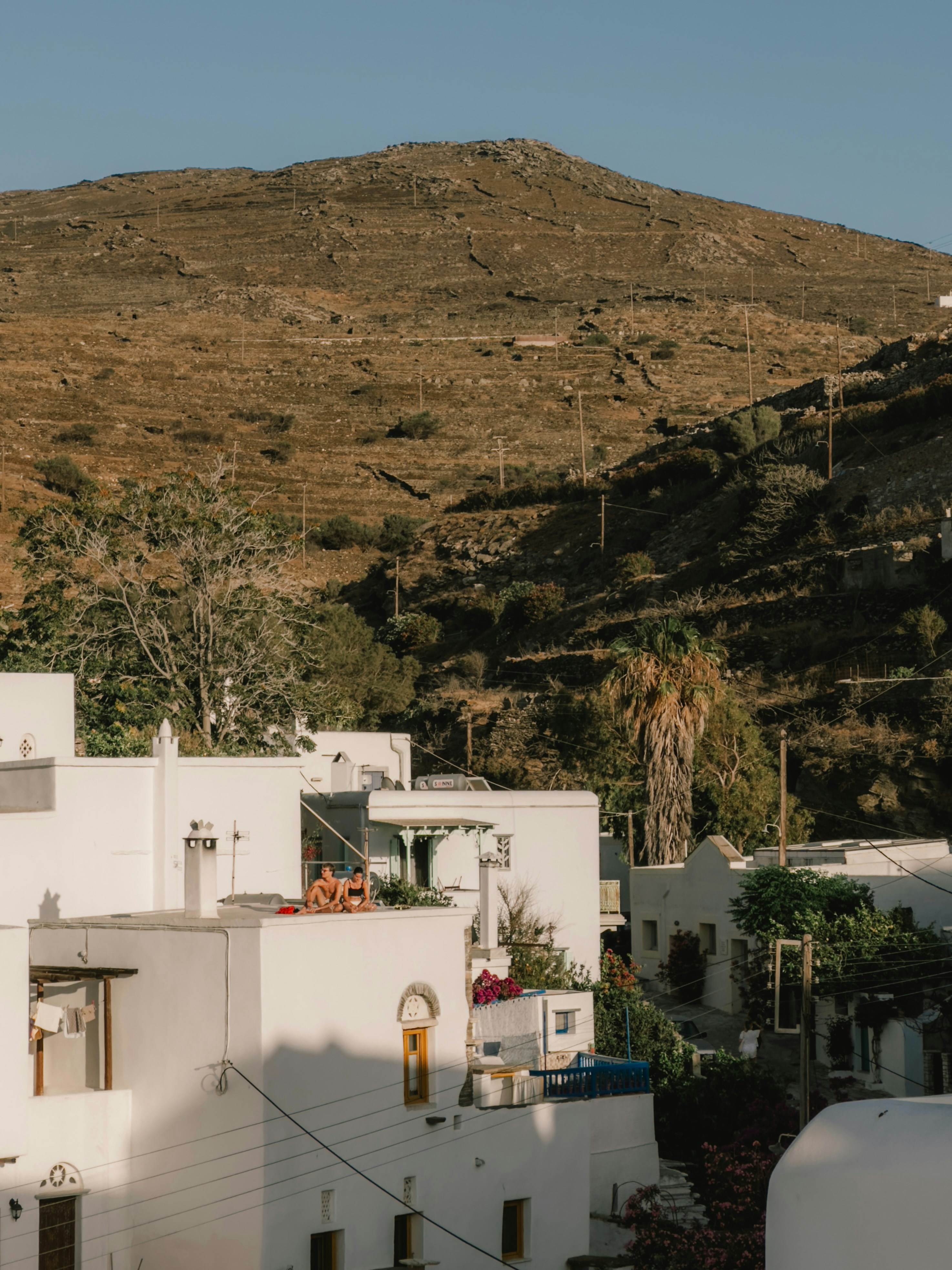 A white building with a mountain in the background