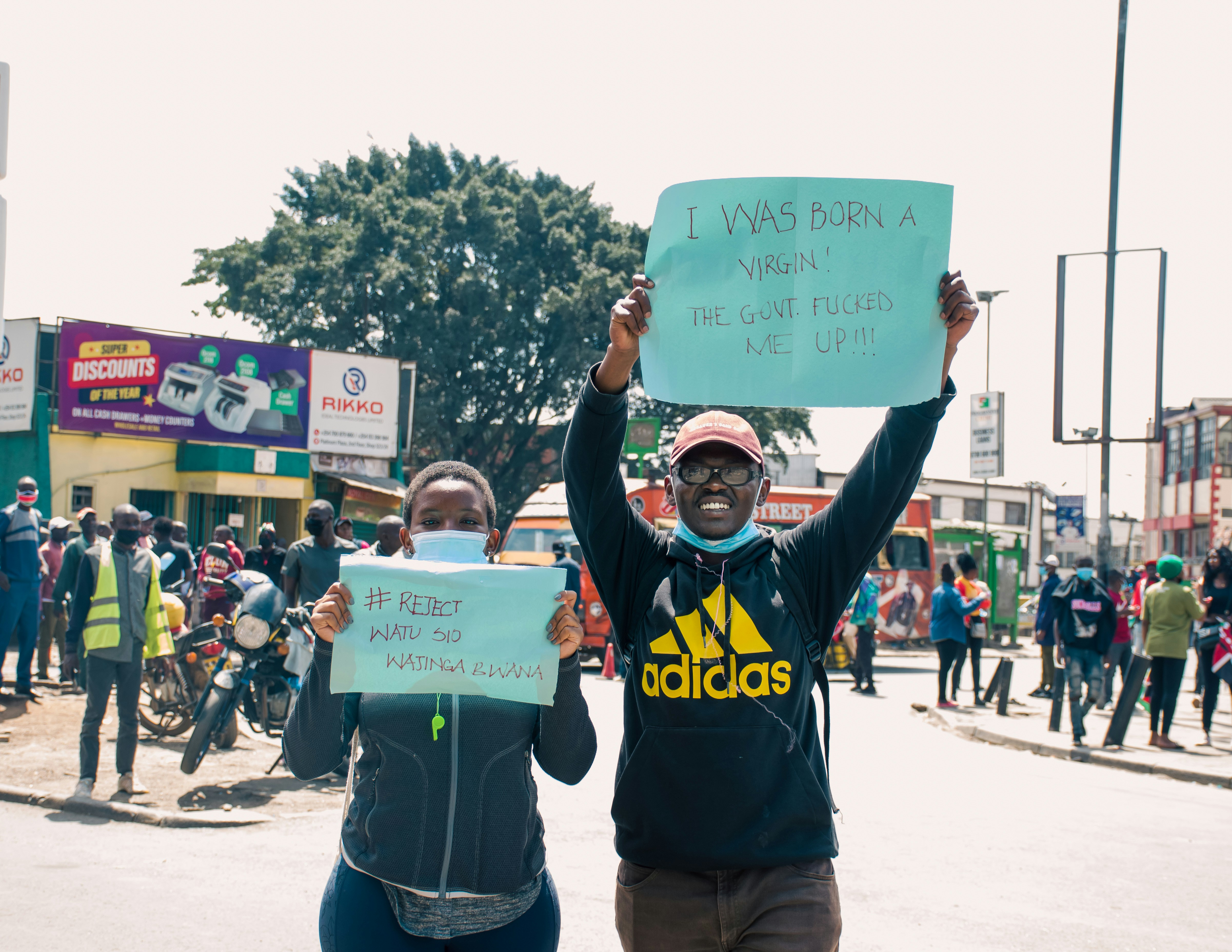 A couple of people that are holding up signs
