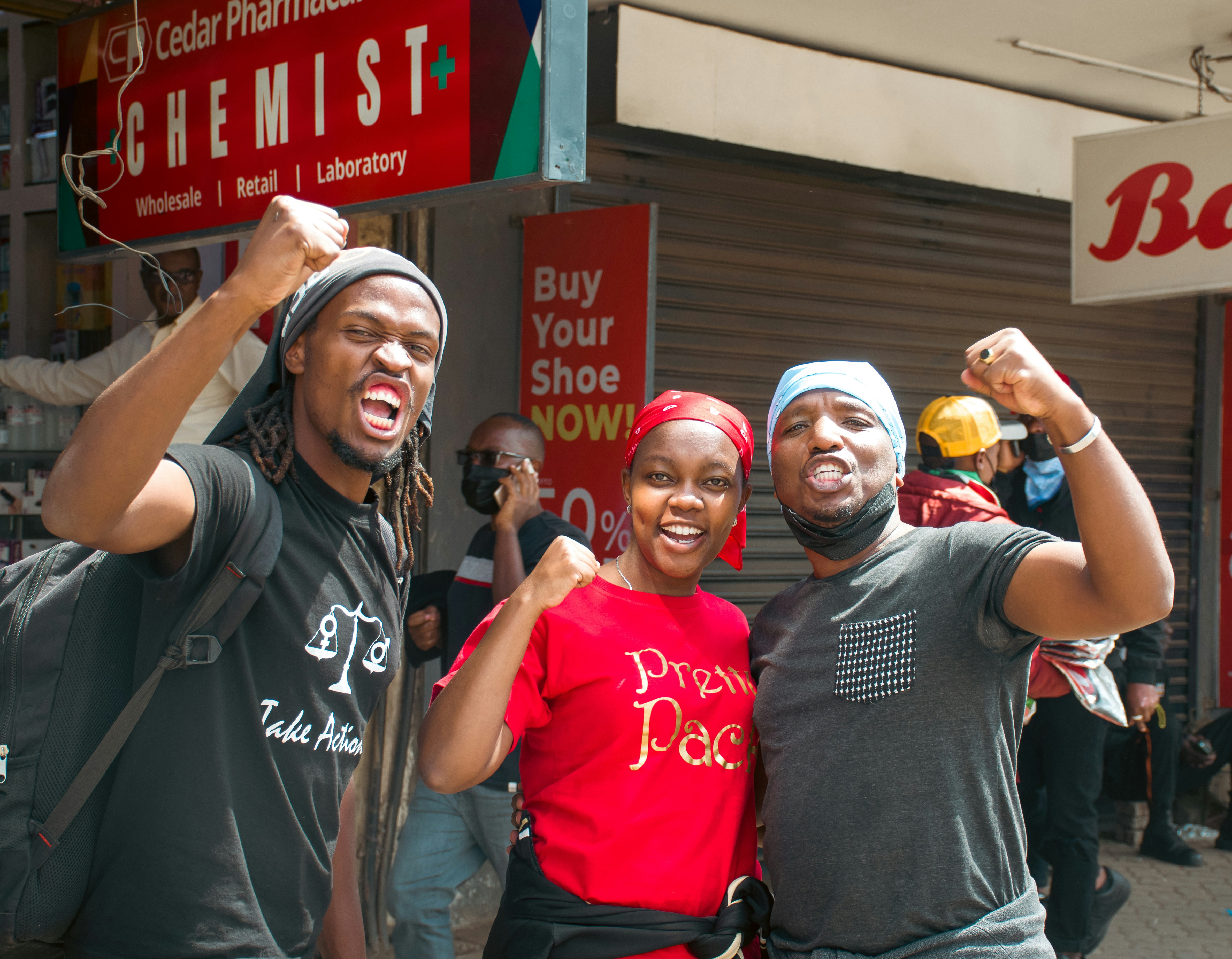 A group of people standing next to each other in front of a store