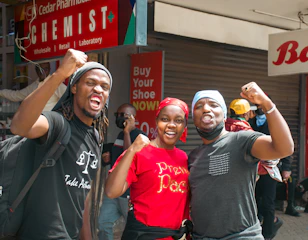 A group of people standing next to each other in front of a store