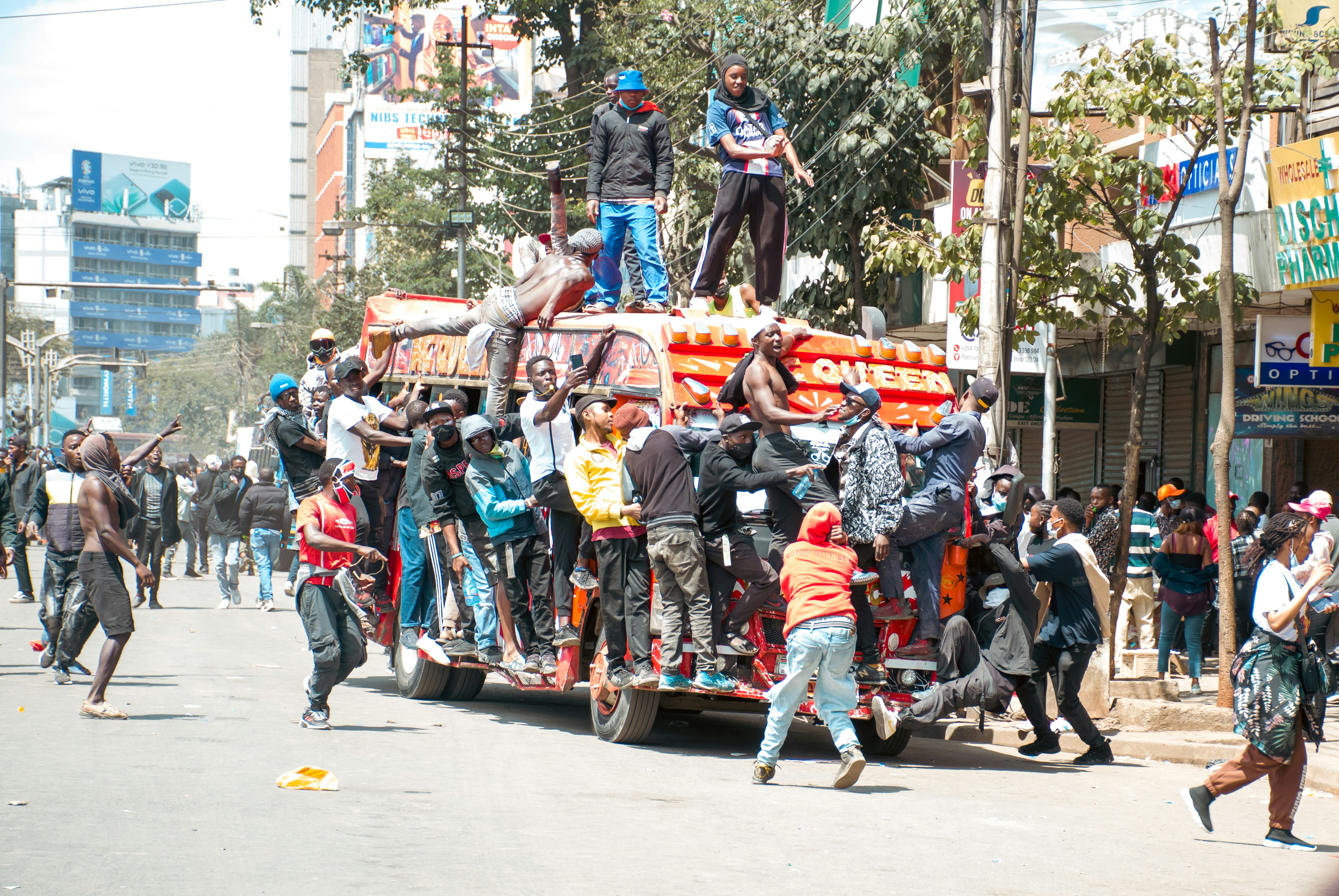 A group of people standing on top of a truck
