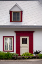 A white and red house with a red door