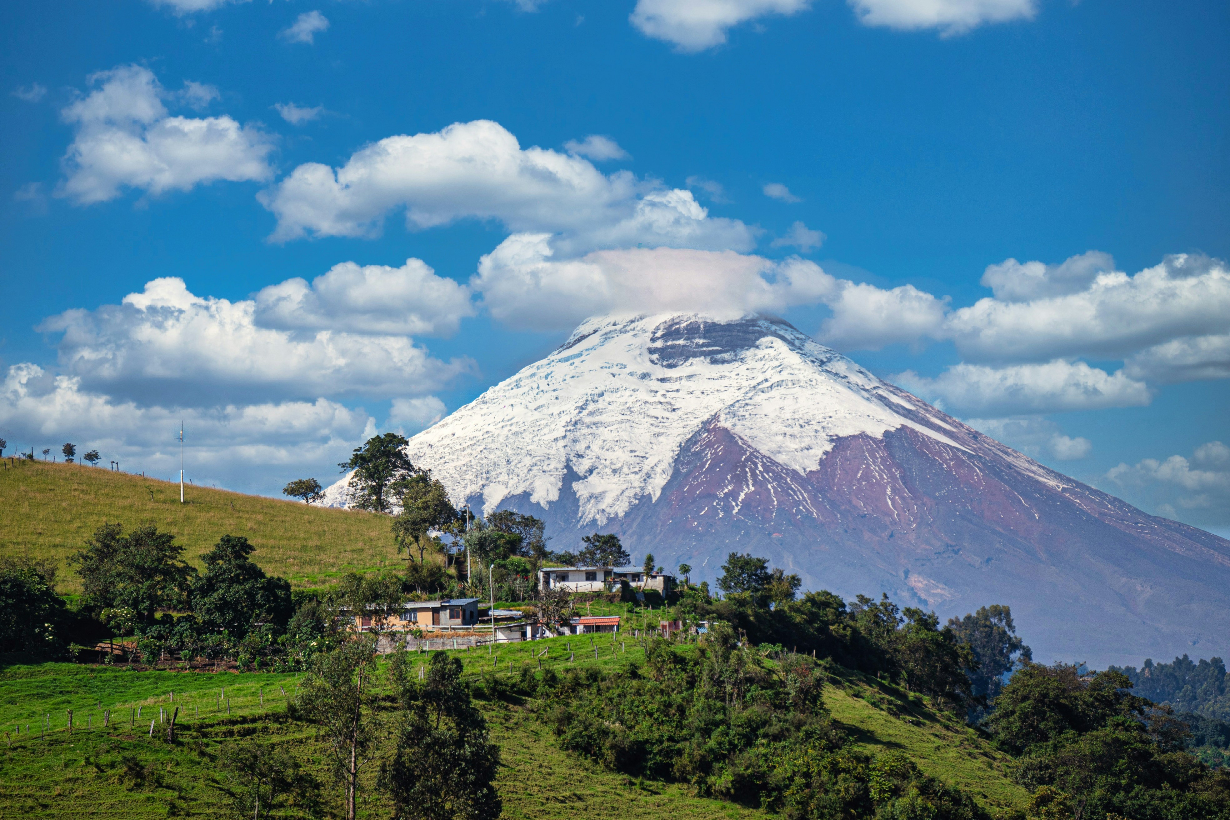 A mountain with a house on top of it