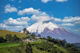 A mountain with a house on top of it