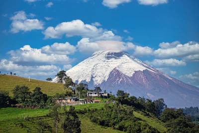 A mountain with a house on top of it