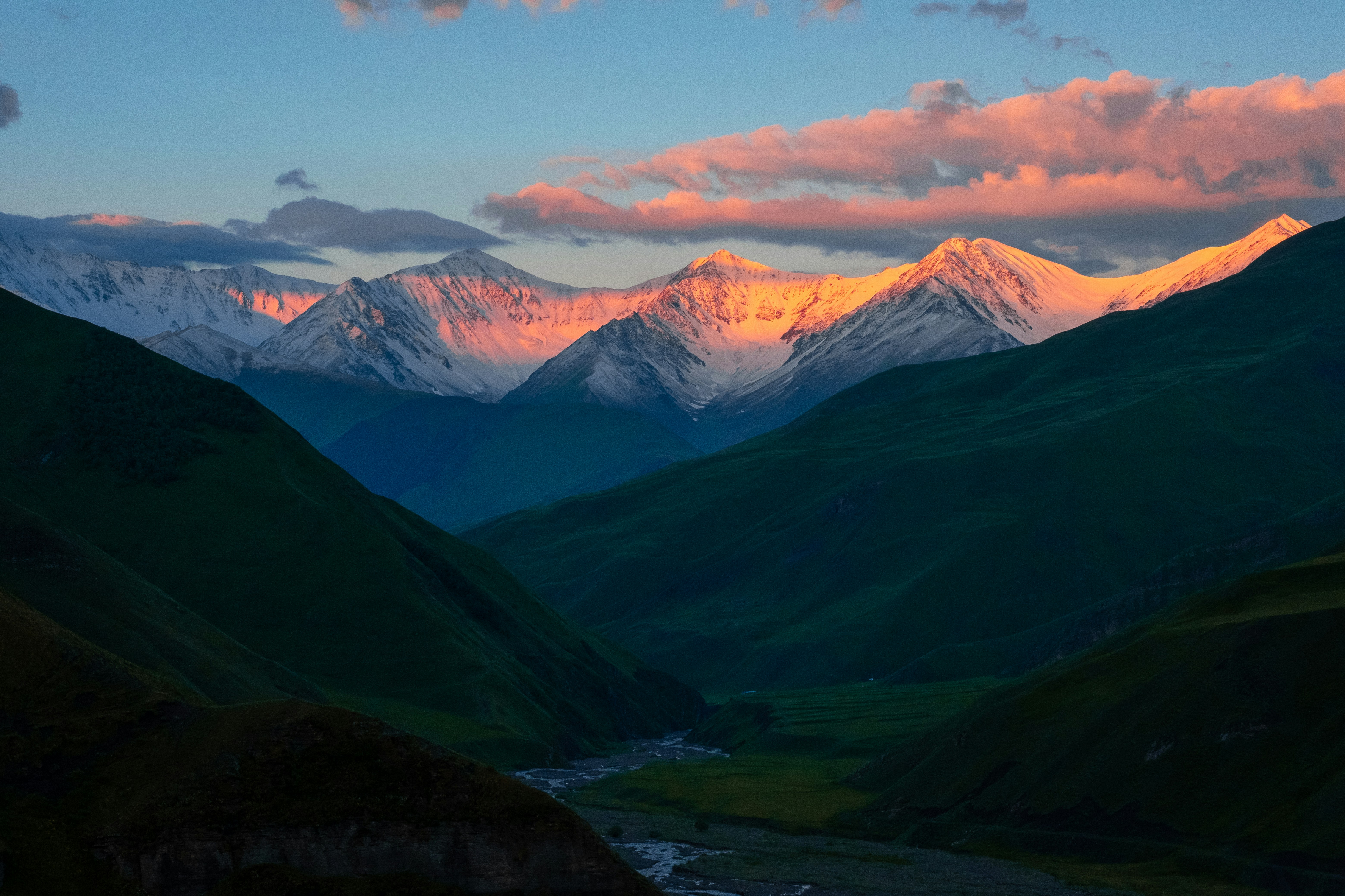 A view of a valley with mountains in the background