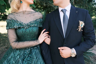 A man in a suit and a woman in a green dress