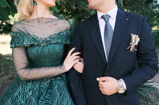 A man in a suit and a woman in a green dress