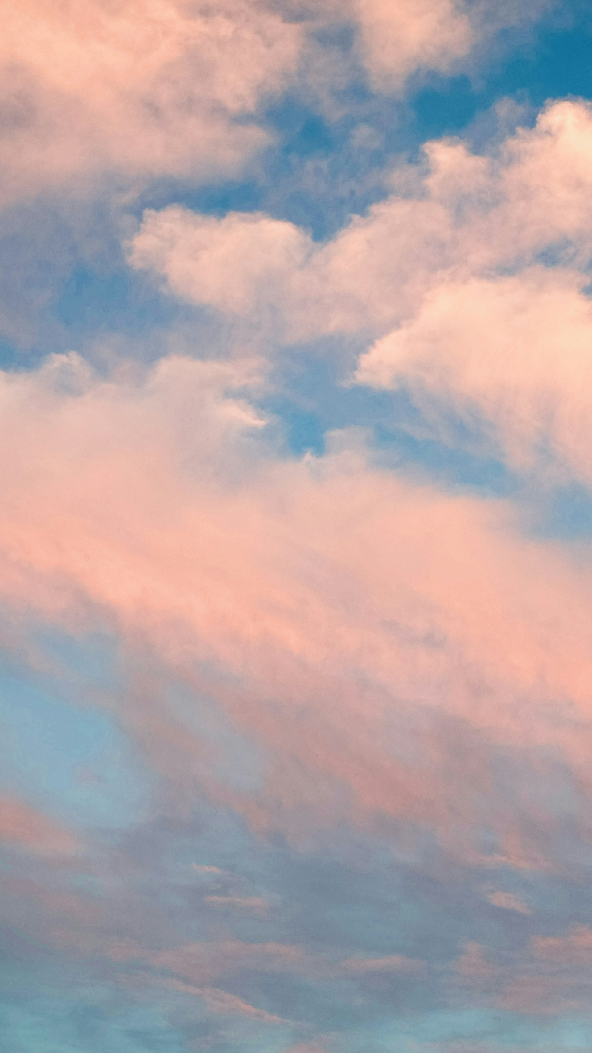 A plane flying in the sky with clouds