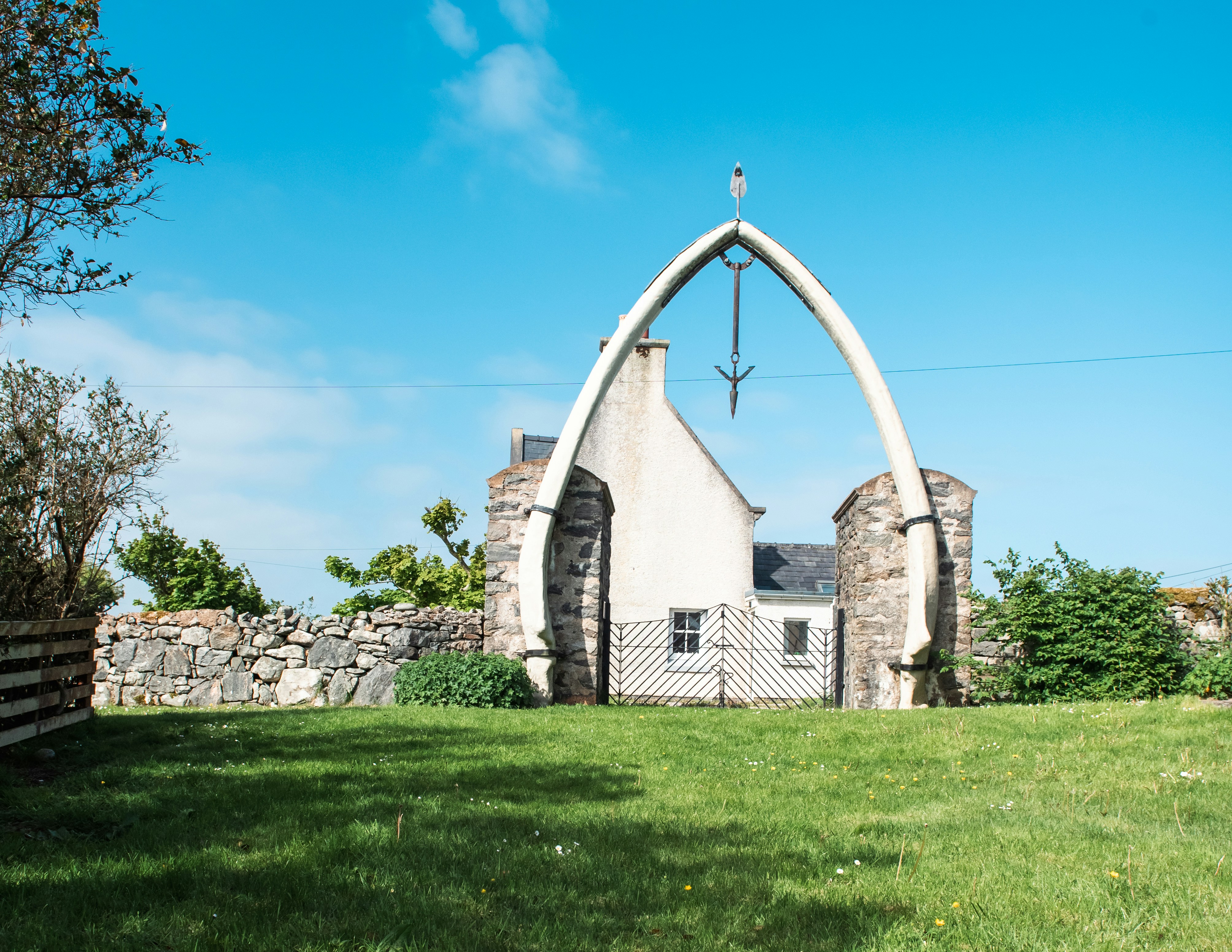 A white church with a cross on top of it