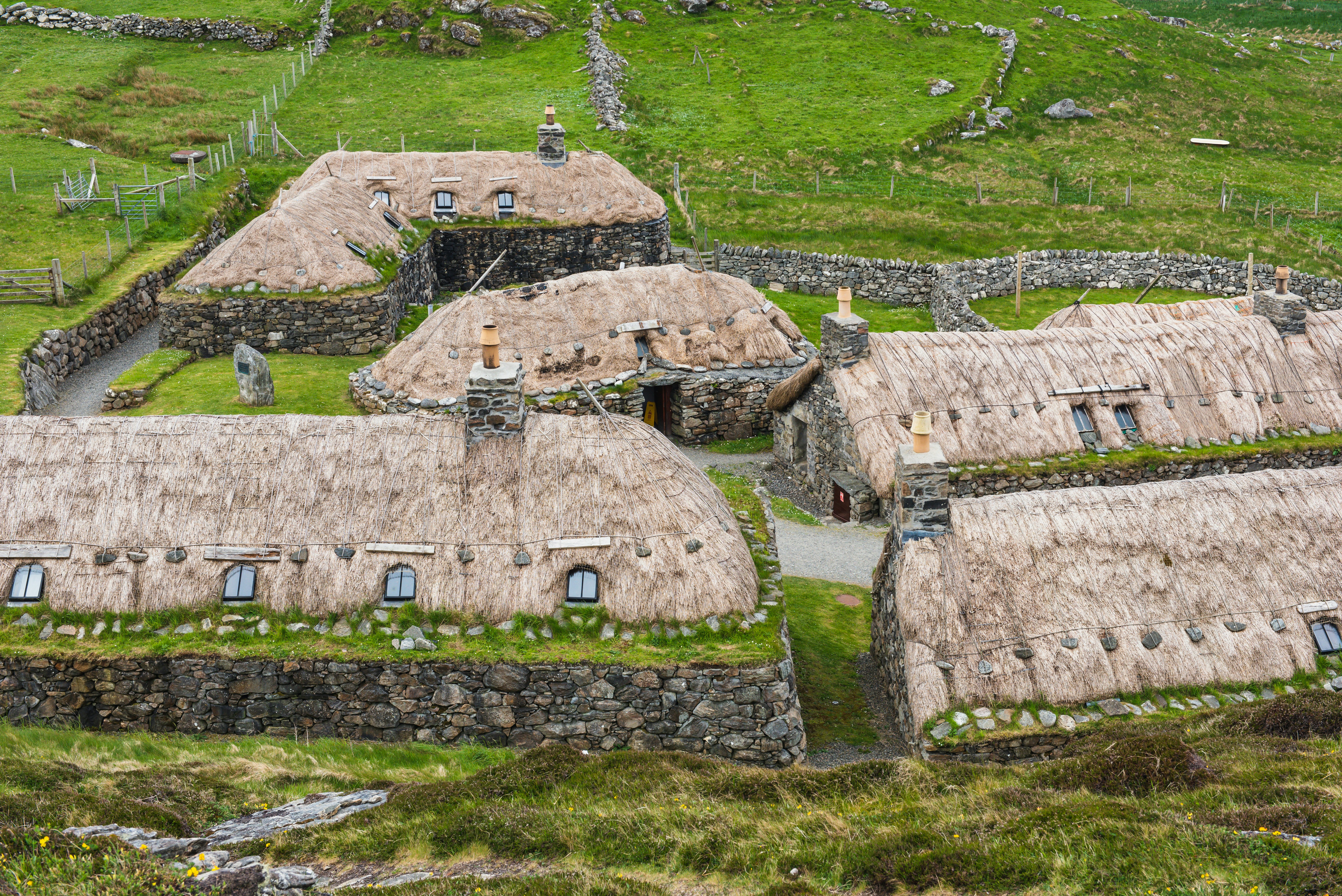 An aerial view of a village in the middle of a field